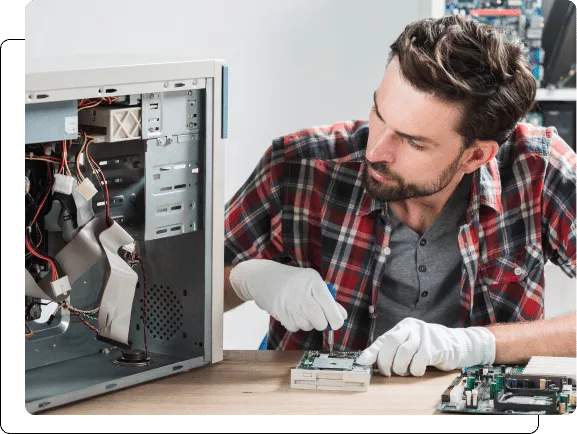 Technician repairing computer hardware.